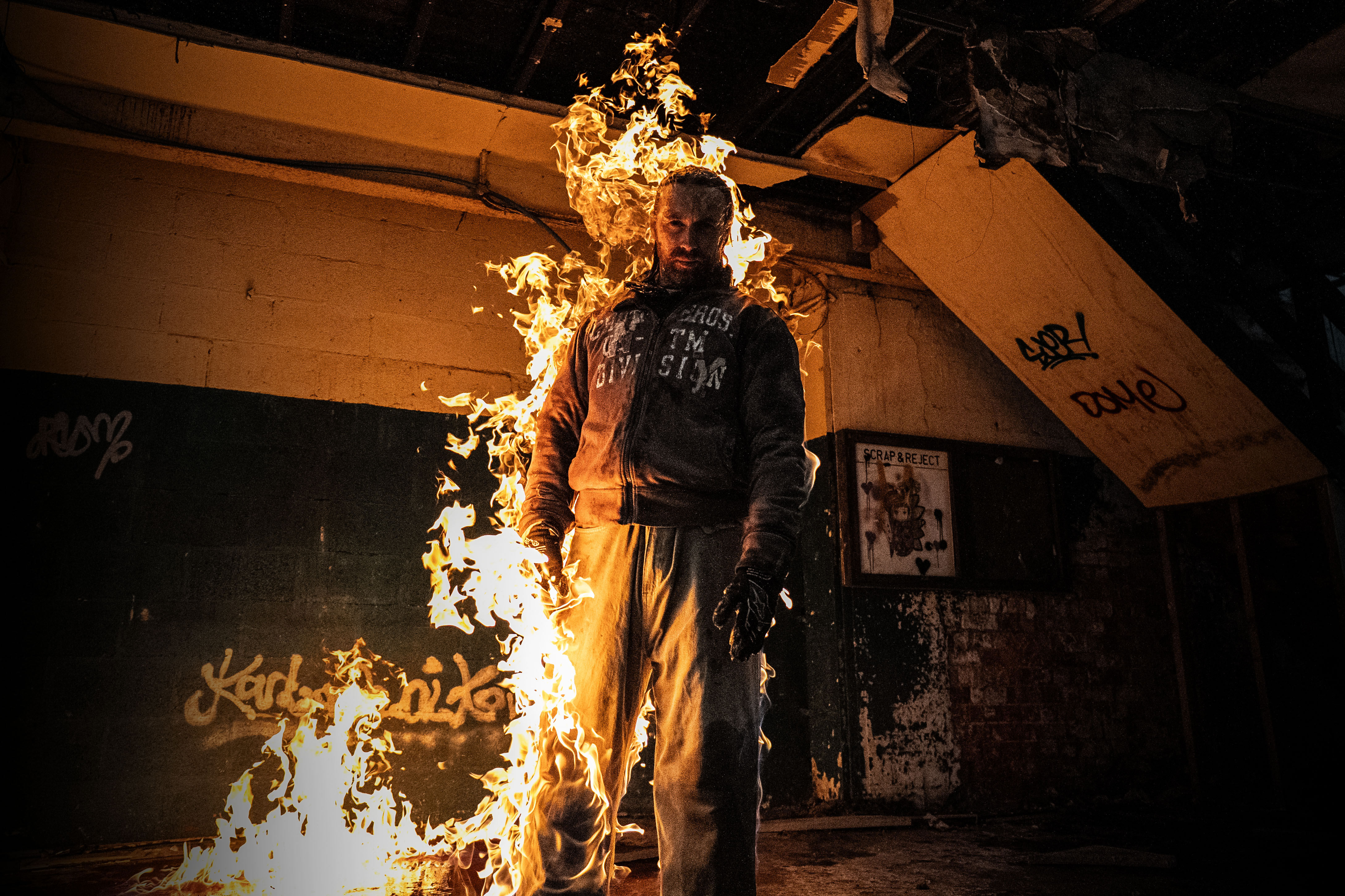 Fire stunt performer in full protection gear